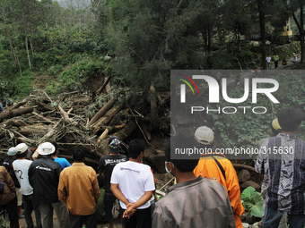 Residents look at debris timber of cold lava eruption of Mount Sinabung has been eroding for landslide threatens villages Mardinding, Karo,...