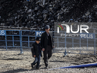 Relatives of miners trapped inside a coal mine flooded with water, wait as search and rescue team work in Ermenek district of Karaman, south...