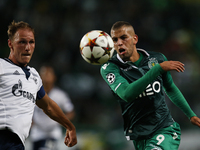 Sporting's forward Islam Slimani (R)  vies for the ball with Schalke 04's defender Benedikt Howedes (L)  during the UEFA Champions League  g...