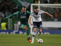 Sporting's forward Islam Slimani (L) vies for the ball with Schalke 04's midfielder Marco Hoger (R)  during the UEFA Champions League  group...