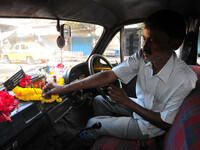 A hindu Taxi Diver Om Prakash Prasad after pray join her daily work at Kolkata Street  on November 07,2014. The maker of India's Ambassador...