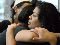 Carmela Apolonio Hernandez and daughter Keyri Artillero Apolonio, 14, embrace after receiving a warning to disperse as a group of protestors...