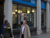 People waling by a branch of the Co-Operative Bank. (