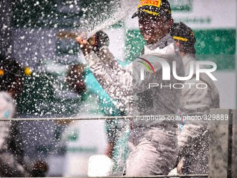 Mercedes AMG Petronas driver Nico Rosberg of Germany celebrates on the podium after winning the Brazilian Formula One Grand Prix at the Inte...
