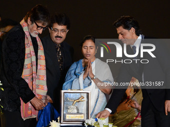 Actor Amitabh Bachhan(L), Chief Minister of West Bengal Mamata Banerjee (C), actor Shah Rukh Khan unveil the golden trophy for top award in...