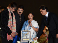 Actor Amitabh Bachhan(L), Chief Minister of West Bengal Mamata Banerjee (C), actor Shah Rukh Khan unveil the golden trophy for top award in...