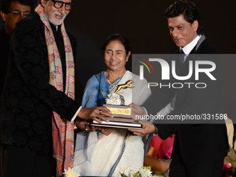 Actor Amitabh Bachhan(L), Chief Minister of West Bengal Mamata Banerjee (C), actor Shah Rukh Khan unveil the golden trophy in the opening ce...