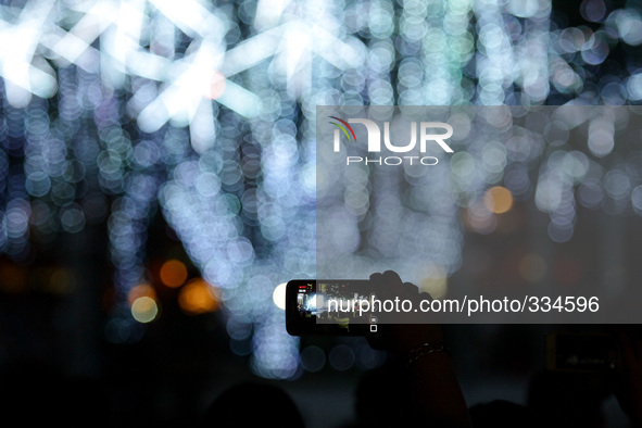 Makati City, Philippines - A spectator records the Festival of Lights with his mobile device in Makati City, south of Manila on November 12,...