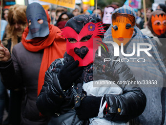 A prostitute with her face covered by a red mask gestures during a protest against the criminalization of prostitution in Madrid, Spain, Sat...