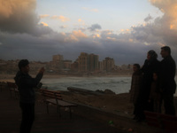 A view shows buildings during  the palestinian family picks up a picture on the shore of the sea in Gaza City, which is experiencing low pre...