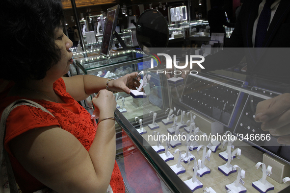 Visitors watch pearl jewelry are displayed during the exhibition in Medan, North Sumatra, Indonesia on Sunday, November 23, 2014. The export...