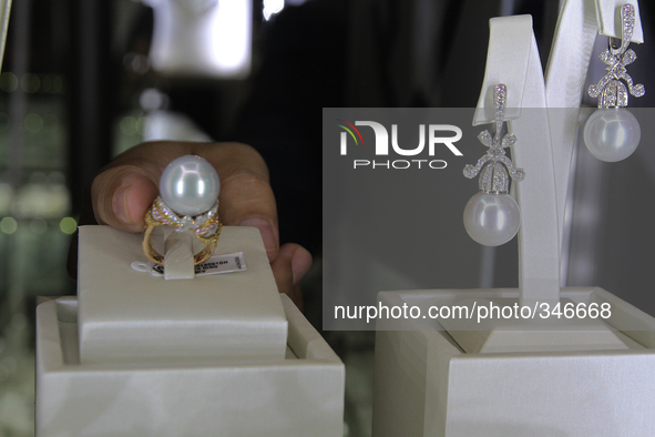 Visitors watch pearl jewelry are displayed during the exhibition in Medan, North Sumatra, Indonesia on Sunday, November 23, 2014. The export...