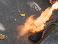 People who participate in the march of students for public education in Bogota, Colombia, on 28 November 2018. burn a cap of a police office...