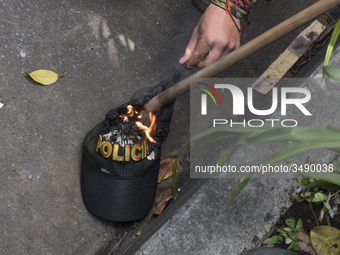 People who participate in the march of students for public education in Bogota, Colombia, on 28 November 2018. burn a cap of a police office...