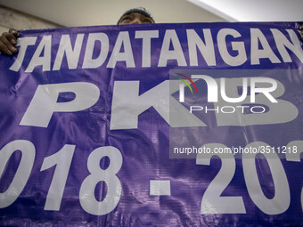Jakarta, Indonesia, 04 December 2018 : Employee with poster that demanding the agreement of Employee and company. hundreds of Indonesian New...