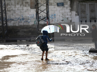 Children returning from school who walks the street during rain 'has hit Gaza very low in the past 3 days and so far(