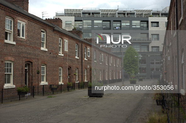 A residential street on November 27, 2014, in Manchester city centre on which are two rows of terraced houses. At the end of the row is a mu...