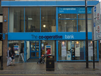 People walking by, as one person is withdrawing money from, a Co-Operative Bank in central Preston on November 27, 2014. (