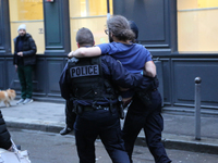 An injured man is treated by policemen after the explosion of a bakery on the corner of the streets Saint-Cecile and Rue de Trevise in centr...