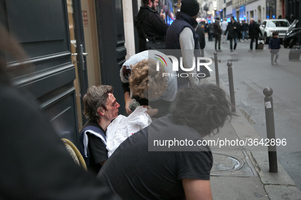 An injured man is treated by emergency workers after the explosion of a bakery on the corner of the streets Saint-Cecile and Rue de Trevise...