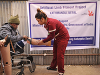 A Nurse helps to fit artificial Prosthetic legs during Artificial limb fitment camp in Norvic International Hospital, Kathmandu, Nepal on Su...