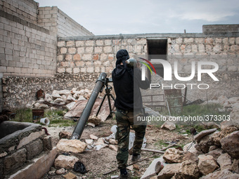 One of the rebels carrying mortar shell, in Aleppo, Syria, on December 13, 2014.  (