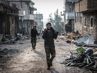 Two of the rebels carrying mortar shells, in Aleppo, Syria, on December 13, 2014.  (