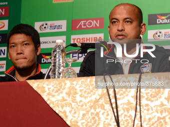 Thailand assistant coach Choketawee Promrut (R) addresses during a press conference of the AFF Suzuki Cup 2014 final round 1st leg Thailand...
