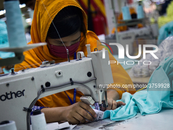 Workers at a garment factory work at MB Knit garment factory in Narayanganj, near Dhaka. (