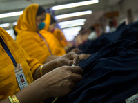 Workers at a garment factory work at MB Knit garment factory in Narayanganj, near Dhaka. (