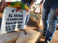 Kurds visit a makeshift cemetery on the border of Kobane to pay respect to the 66 YPG fighters who are currently buried only a few kilometer...