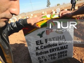 Kurds visit a makeshift cemetery on the border of Kobane to pay respect to the 66 YPG fighters who are currently buried only a few kilometer...