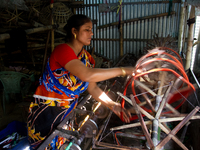 A female worker is spinning inside a handloom factory on 21 December 2014 in Pabna, Bangladesh. 
Bangladesh has a glorious long tradition o...