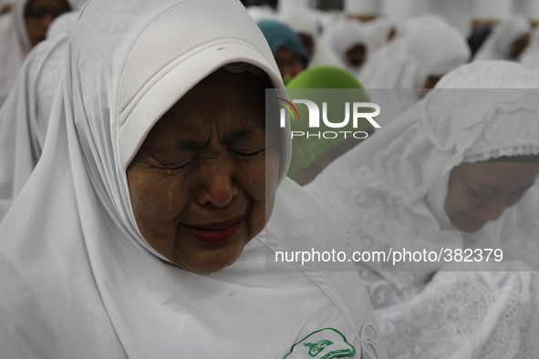 Acehnese women cry during their prayer for tsunami victims ahead of the 10th anniversary in Baiturrahman Grand Mosque in Banda Aceh, Aceh pr...