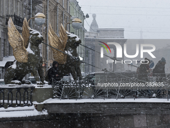 People on the Bank Bridge on Griboyedov channel during heavy snowfall in St.Petersburg, Russia, 28 December 2014 (