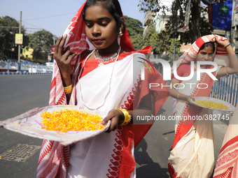 Bengali girls wearing traditional red and white sari during a NABC 2015 curtain raiser in Kolkata, Indiaon 28th December 2014.
NABC or Nort...