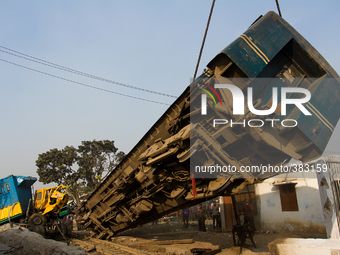 Fallen train is being pulled out of the accident scene by the rescue train of BD railway on December 28, 2014 in Dhaka, Bangladesh. (