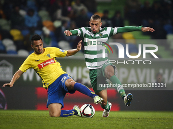Sporting's forward Islam Slimani (R) vies with Estoril's defender Ruben Fernandes during the Portuguese League  football match between Sport...