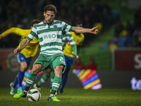 Sporting's midfielder Adrien Silva scores a penalty kick during the Portuguese League  football match between Sporting CP and Estoril Praia...