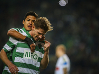 Sporting's midfielder Adrien Silva (front) celebrates with Sporting's forward Fredy Montero after scoring  during the Portuguese League  foo...