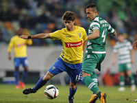 Sporting's defender Jefferson  (R) vies for the ball with Estoril's midfielder Matias Cabrera (R)  during the Portuguese League  football ma...