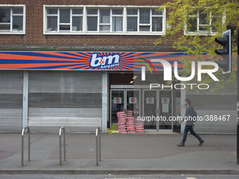 A person walking by a B&M Bargains store. (