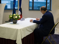 The Tunisian ambassador to The Netherlands, Mohamed Ben Becher is seen signing the condolence registry in the French embassy in The Hague on...