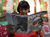 Makati, Philippines - Teresita Janoras, 61 from Makati reads a magazine about Pope Francis on Monday, January 12, 2015. The Pope will be vis...
