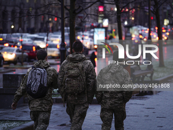 Three young men in military uniforms are seen in Kyiv, Ukraine on March 27, 2019. Ukraine has been stuck in a frozen conflict with Russia ov...