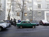 A vintage Soviet car is seen parked in front of the administrative building of the Verkhovna Rada, parliament in Kyiv, Ukraine on March 28,...