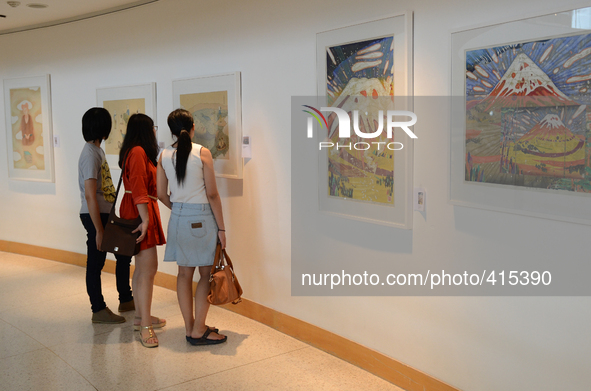 Tourists looks at a painting at Bangkok Art and Culture Centre in Bangkok, Thailand on January 31, 2015. Thailand finance ministry cuts econ...