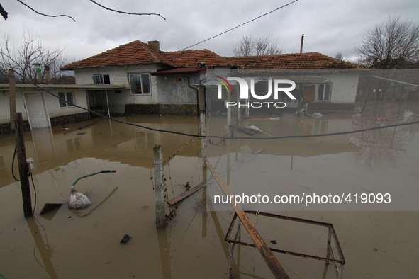 People walk at their flooded homes as try to save belongings in the town of Dalgopol, north-east of the Bulgarian capital Sofia, Tuesday, Fe...