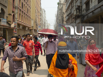 Workers coming out from different garments factories on their way home during lunch break in Narayanganj on April 24, 2019. (