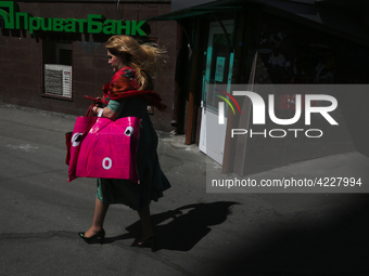 A woman walks past the entrance of the branch of Privat Bank in Kyiv, Ukraine, April 26, 2019. Kyiv District Administrative Court ruled that...
